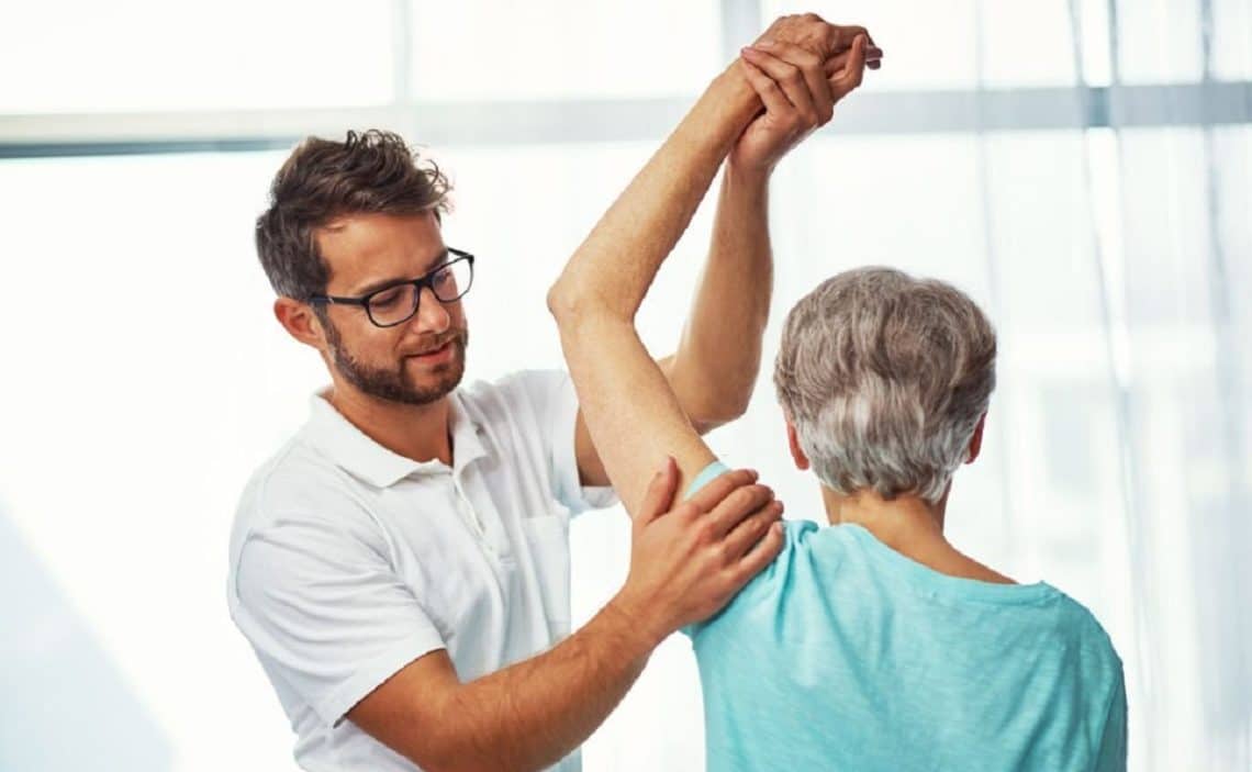 Physiologist treating a patient