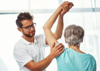 Physiologist treating a patient