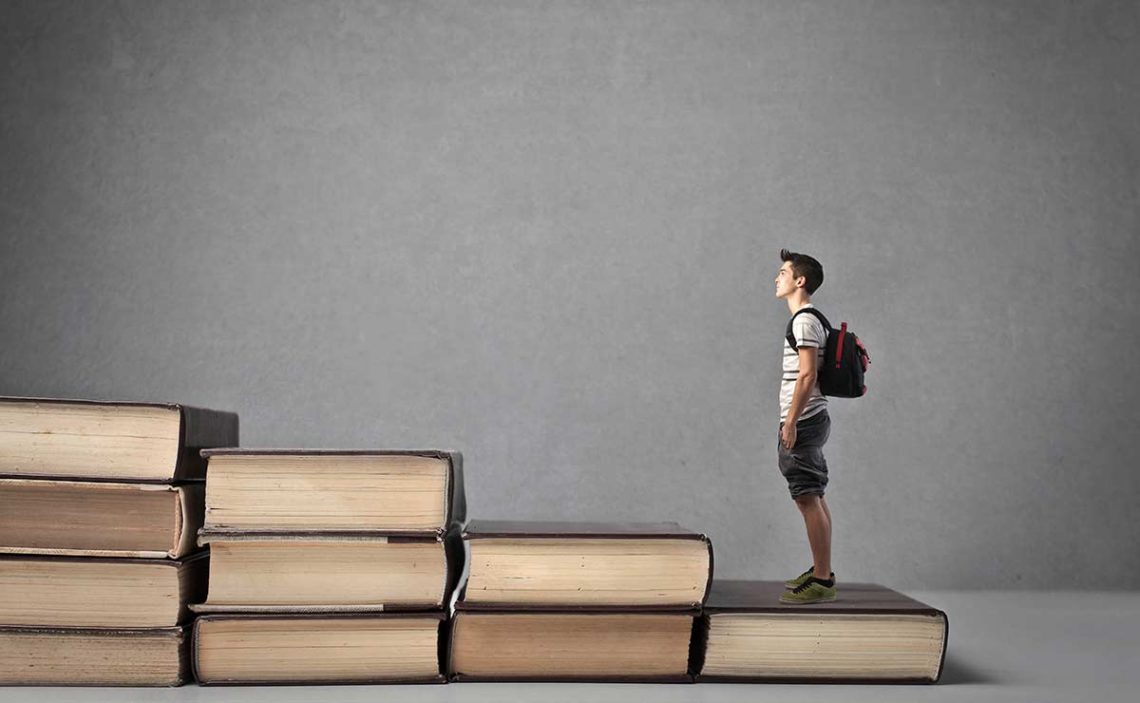 Person standing on books