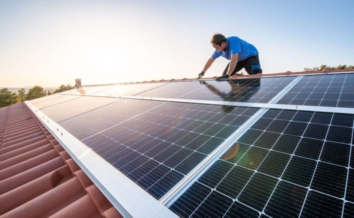 Professional installing a solar panel in a roof