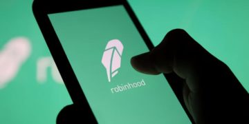 Hand holding phone with robinhood image