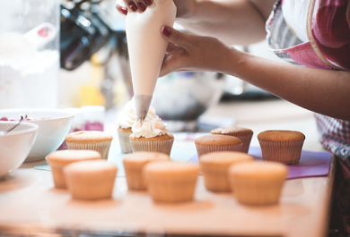 Student baking cupcakes for extra money