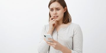 Girl feeling nervous receiving money via app from unkown person