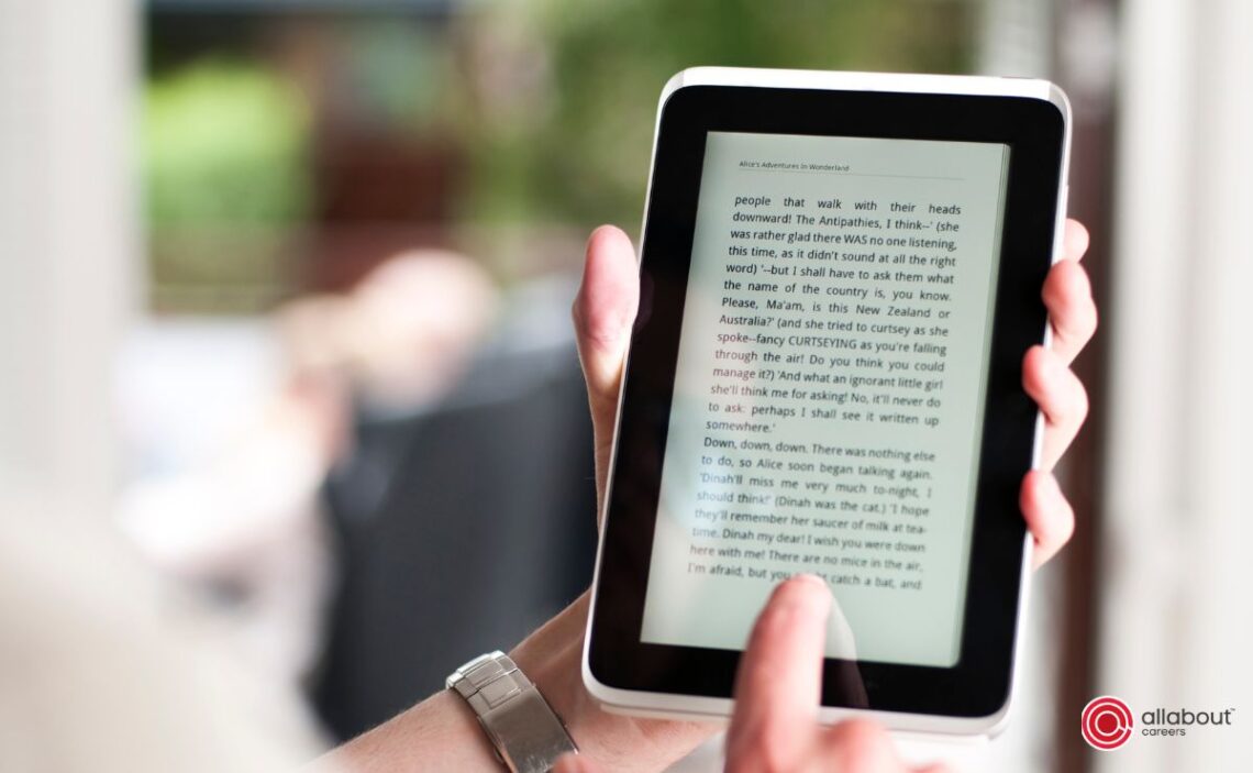 person reading a book on a tablet