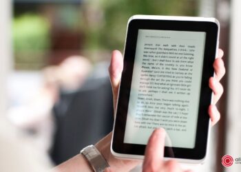 person reading a book on a tablet