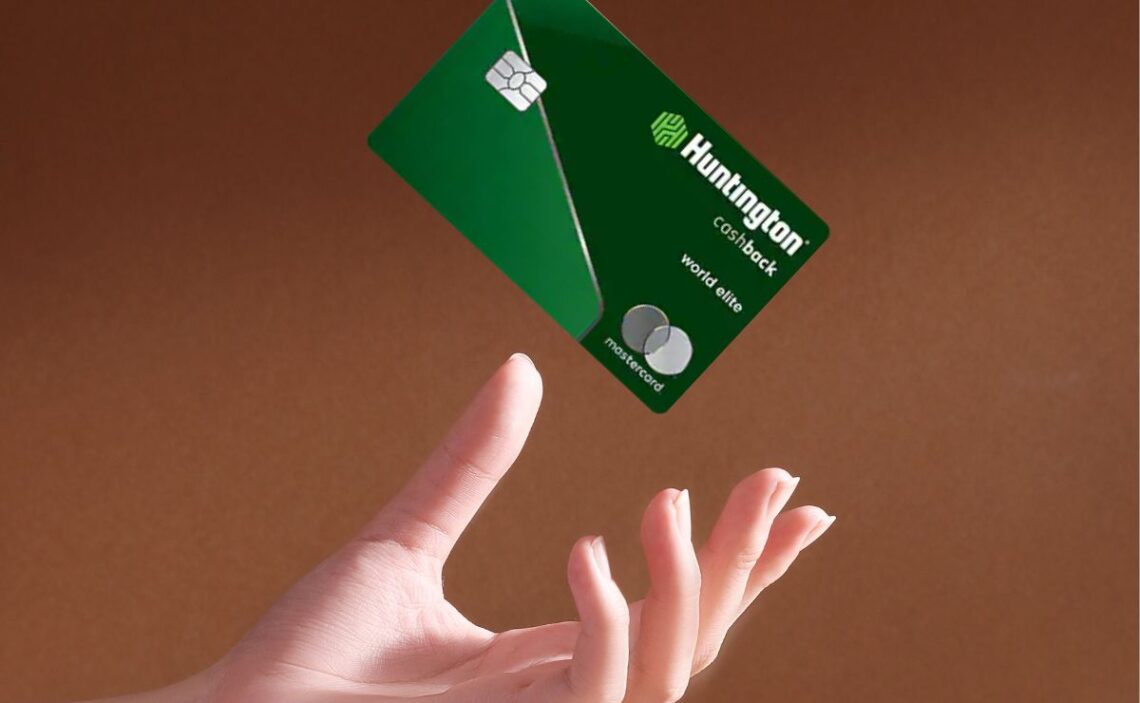 Hand throwing up a Huntington Cashback Credit Card