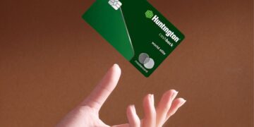 Hand throwing up a Huntington Cashback Credit Card