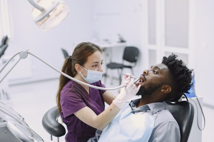African patient in dentistry sitting in dental chair