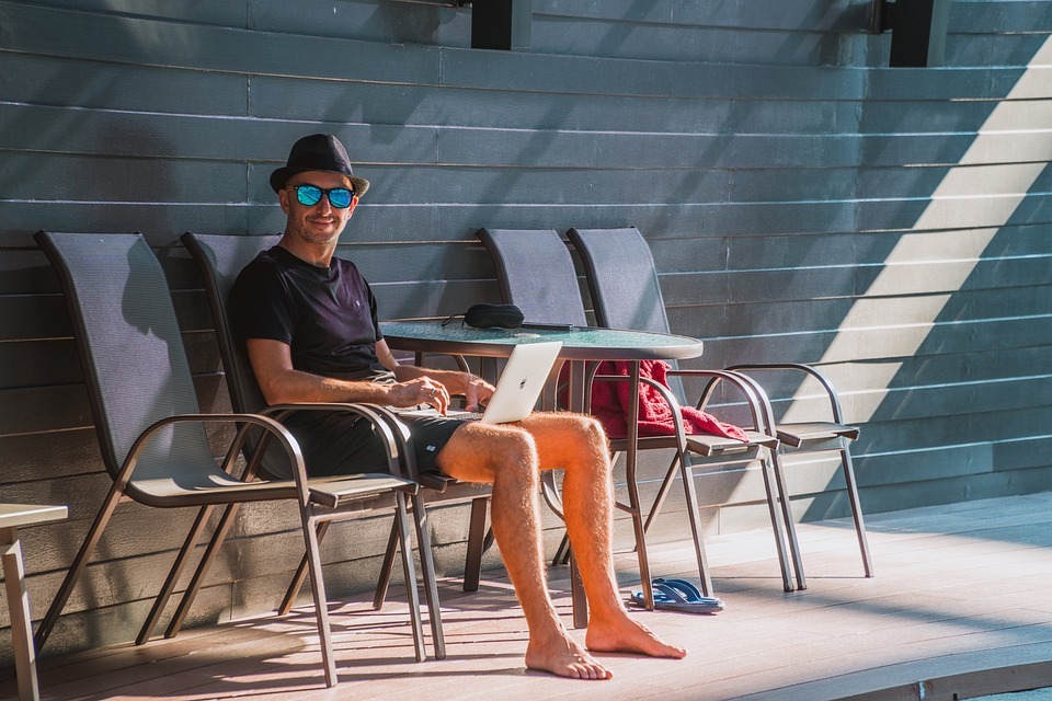 man near pool work remotly