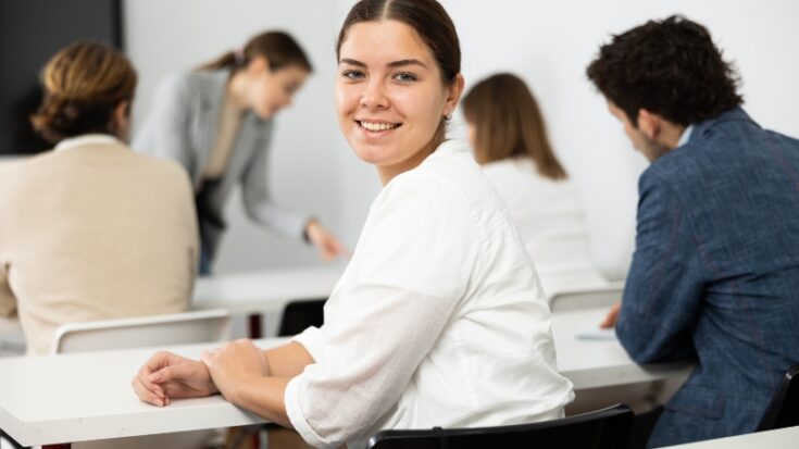 Student in a classroom looks back with confidence while others focus on their work