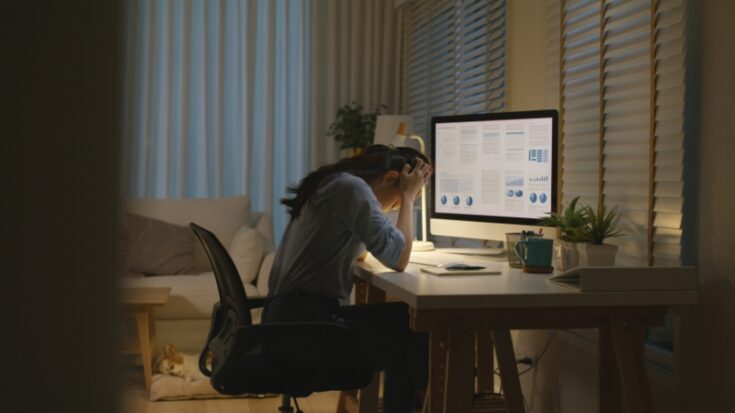 Person sits stressed at a desk at night after choosing a wrong major